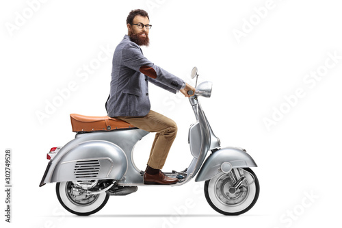 Bearded man riding a vintage scooter
