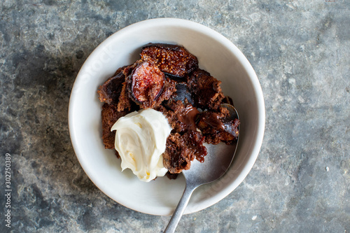 Ottolenghi fig sponge cake with whipped cream in bowl photo