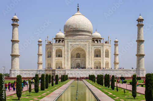 View of Taj Mahal with walkway, garden square, reflecting pool and visitors. UNESCO World Heritage in Agra, Uttar Pradesh, India