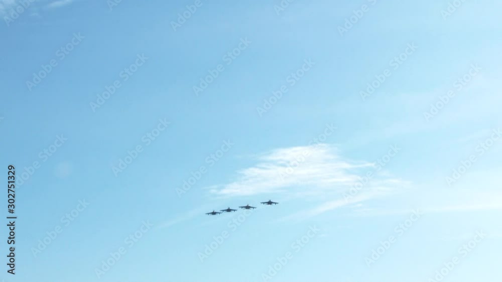 Column of four military warplanes flies over the ground. Military helicopters and planes in the evening sky. Column of four military warplanes flies over the ground. Military helicopters and planes in the evening sky.