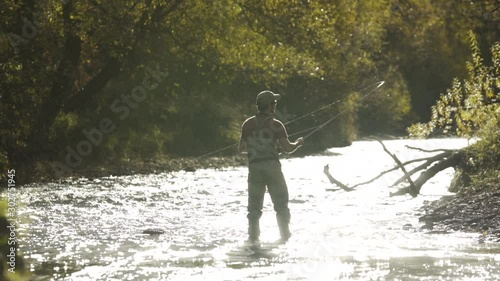 Guy fisherman fly fishing casting line Kawarau River photo