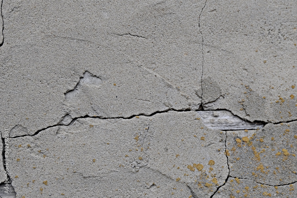 Obraz premium Wall background texture. Gray plaster in cracks. For design and web design, creating games 3D texturing. Wall murals.