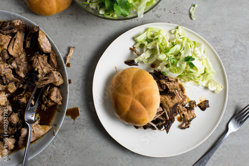 Slow cooked BBQ country style pork with bun and salad