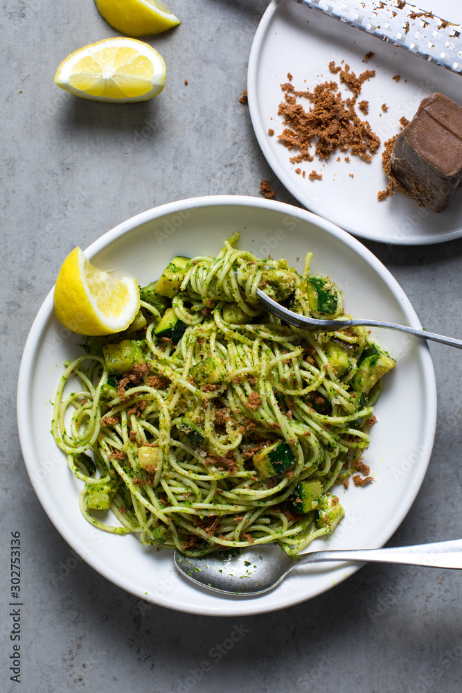 Overhead view of spaghetti with zucchini, parsley pesto and bottarga Overhead view of spaghetti with zucchini, parsley pesto and bottarga