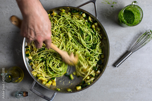 Overhead view of spaghetti with zucchini, parsley pesto and bottarga