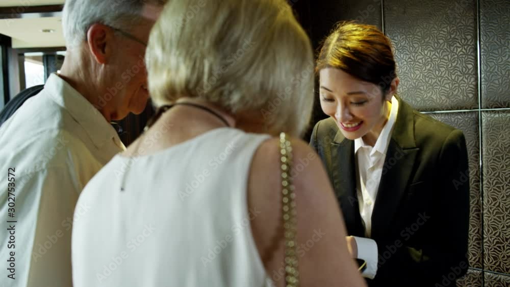 Retired couple at hotel reception desk Hong Kong
