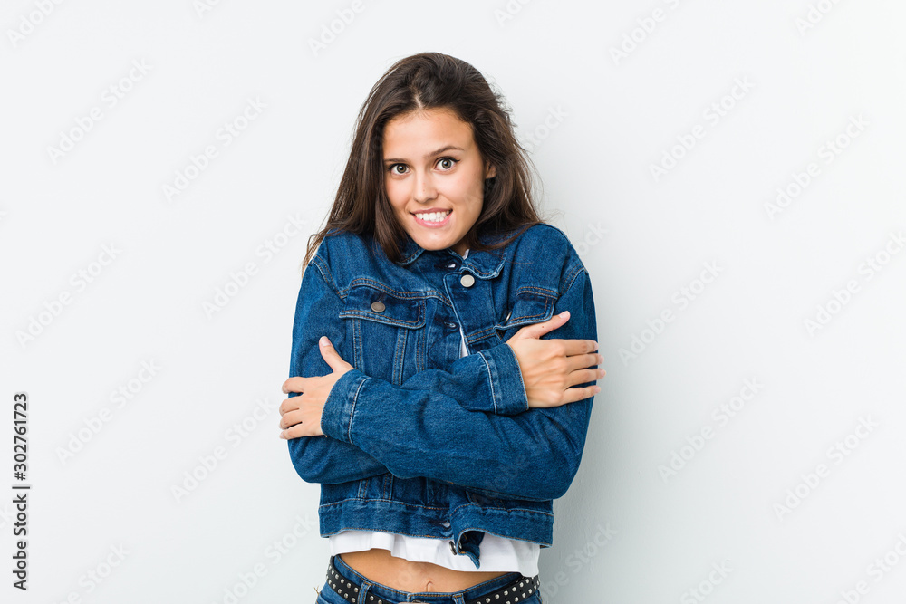Young cute woman going cold due to low temperature or a sickness. Young cute woman going cold due to low temperature or a sickness.