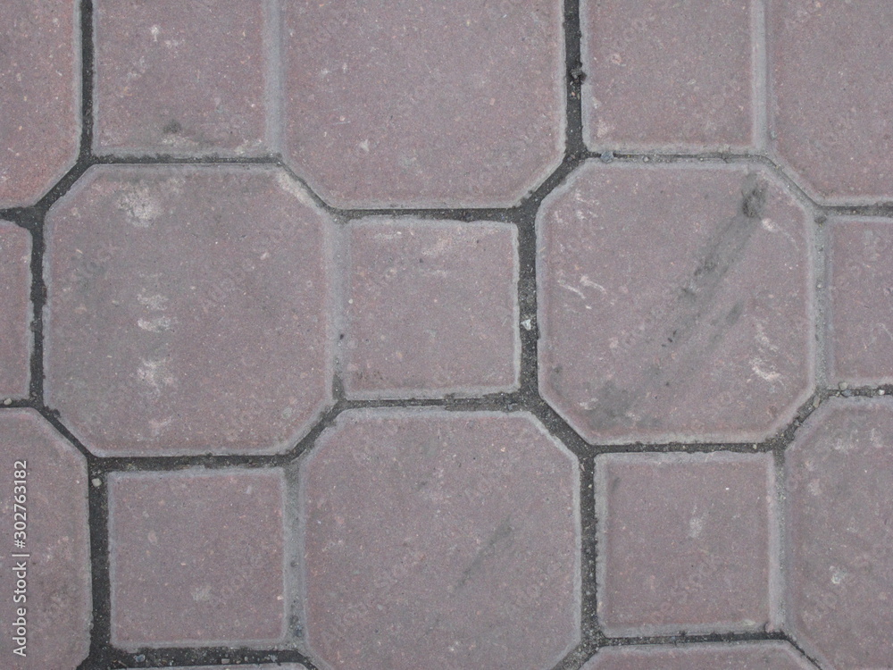 Curly gray tile on the sidewalk of the street Curly gray tile on the sidewalk of the street