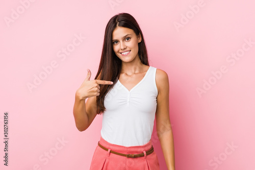 Young cute woman person pointing by hand to a shirt copy space  proud and confident