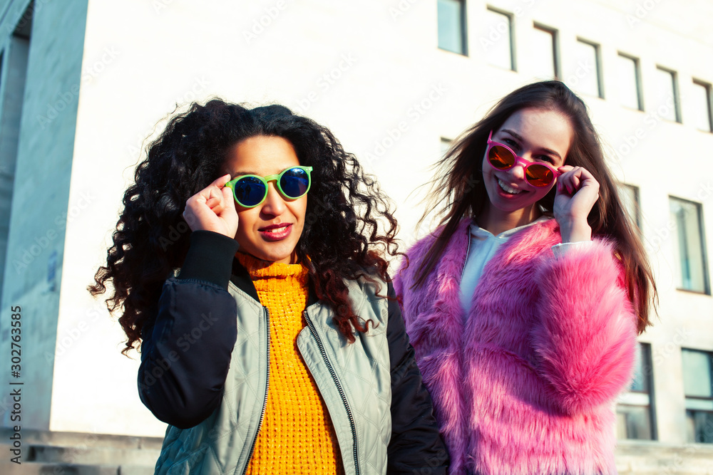 two pretty student girlfriends happy smiling outside at university building, caucasian and african woman, lifestyle people concept two pretty student girlfriends happy smiling outside at university building, caucasian and african woman, lifestyle people concept