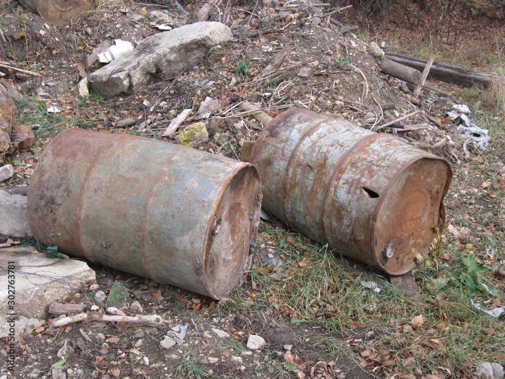 Iron rusty water barrels on the ground