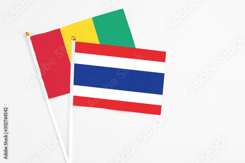 Thailand and Guinea stick flags on white background. High quality fabric, miniature national flag. Peaceful global concept.White floor for copy space. Free Download Thailand and Guinea stick flags on white background. High quality fabric, miniature national flag. Peaceful global concept.White floor for copy space. - GFXLoad