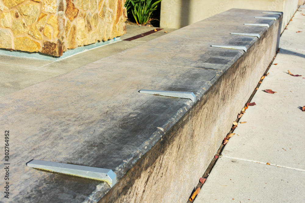 Close up. Skateboard prevention device installed on poured cement surface to prevent damage Close up. Skateboard prevention device installed on poured cement surface to prevent damage