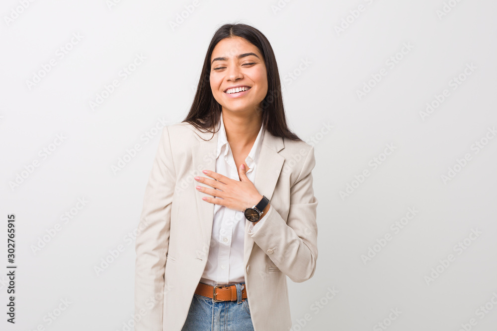 Young business arab woman isolated against a white background laughs out loudly keeping hand on chest. Young business arab woman isolated against a white background laughs out loudly keeping hand on chest.