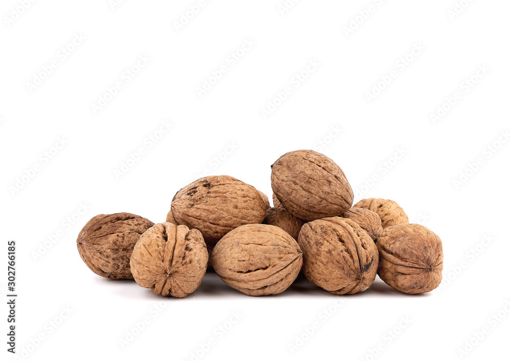 pile of inshell walnuts isolated on a white background pile of inshell walnuts isolated on a white background