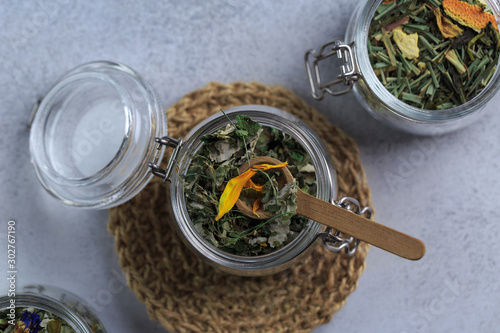 herbal tea in glass pot on grey