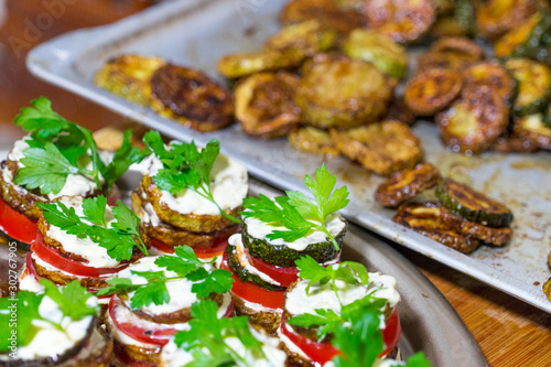 Fried zucchini stacked and served with fresh parsley.