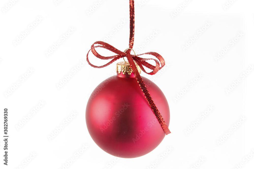a large red Christmas tree ornament hanging on a thin red ribbon isolated  on white Stock Photo
