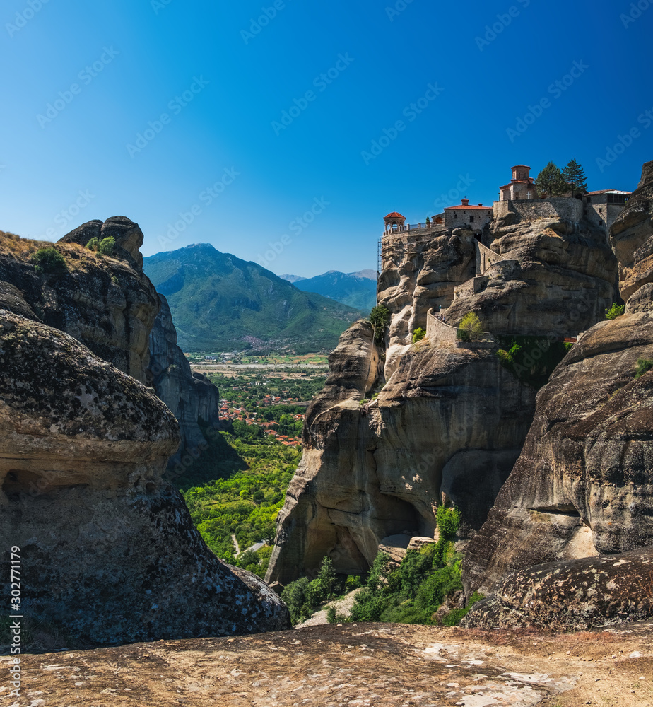 The Monastery of Varlaam is the second largest monastery in Meteora mountains, Thessaly, Greece. Panoramic view of Meteora monastery on the high rock at summer time