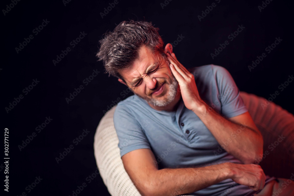 Man feels ear ache. People, healthcare and medicine concept Man feels ear ache. People, healthcare and medicine concept