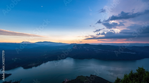 Sunset over the mountains and a lake. Blue colors and a lot of peaceful silence. Sau reservoir, Catalonia, Spain