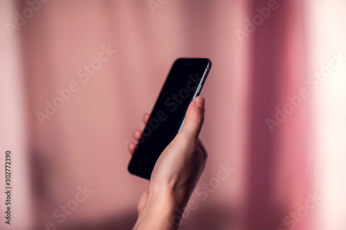 Woman using smartphone at abstract blurred background. People and technology concept