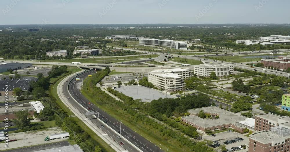 Aerial view of a highway interchange with rush hour traffic during the summer just before sunset in a Chicago suburb. Aerial view of a highway interchange with rush hour traffic during the summer just before sunset in a Chicago suburb.
