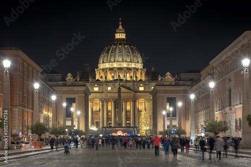 View of the Papal Basilica of St. Peter's in the Vatican illuminated at night (St. Peter's Cathedral) in Rome, Italy.
