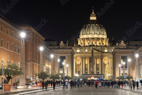 View of the Papal Basilica of St. Peter's in the Vatican illuminated at night (St. Peter's Cathedral) in Rome, Italy.