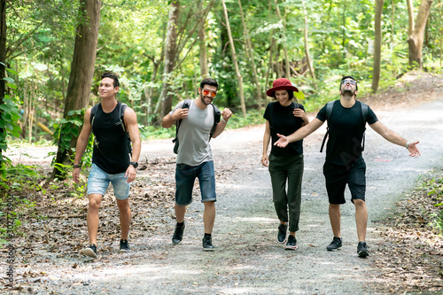 Group Of Friends hiking together through the forest