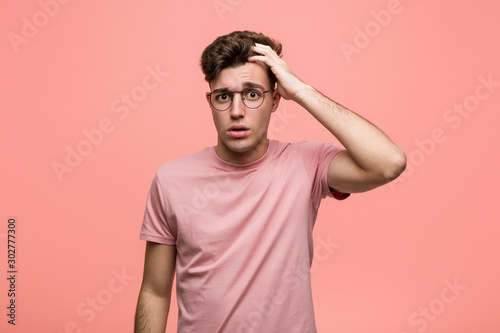 Young cool caucasian man being shocked, he has remembered important meeting.