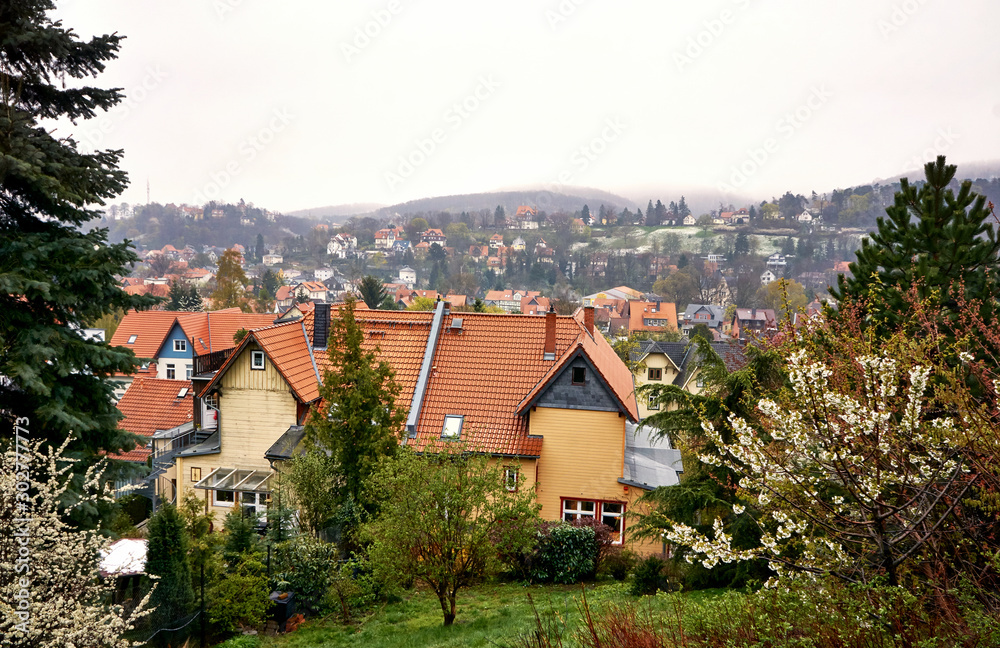View over the historic half-timbered houses on the town of Wernigerode in the fog. Saxony-Anhalt, Germany