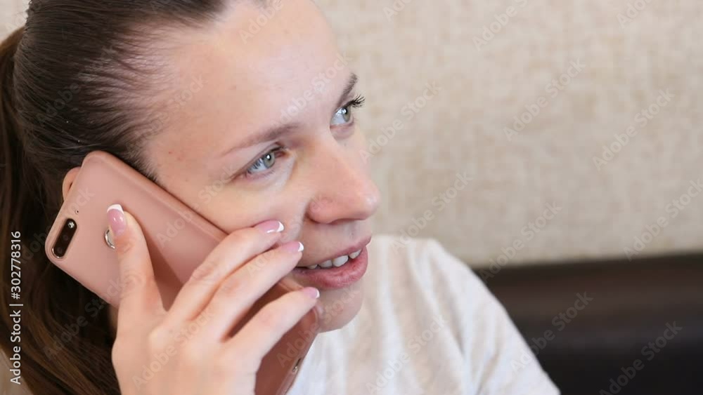 young beautiful girl speaks on the phone. close-up portrait young beautiful girl speaks on the phone. close-up portrait