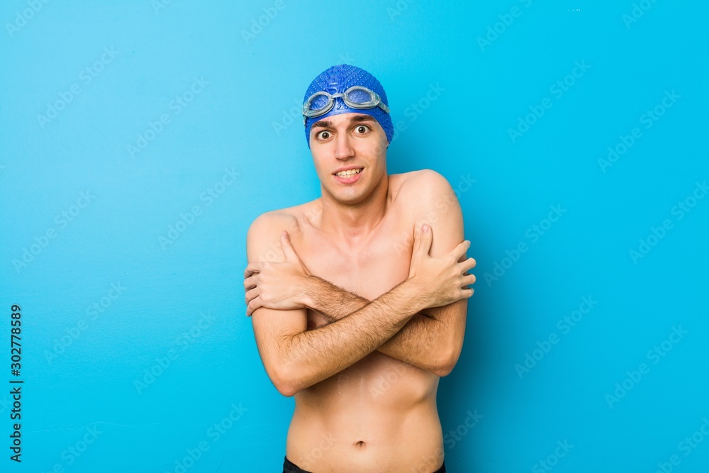 Young swimmer man going cold due to low temperature or a sickness.
