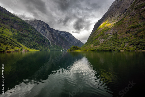 Fjord with reflection of mountains in Norway