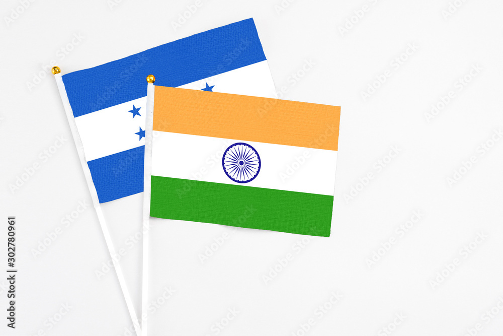 India and Honduras stick flags on white background. High quality fabric, miniature national flag. Peaceful global concept.White floor for copy space. India and Honduras stick flags on white background. High quality fabric, miniature national flag. Peaceful global concept.White floor for copy space.