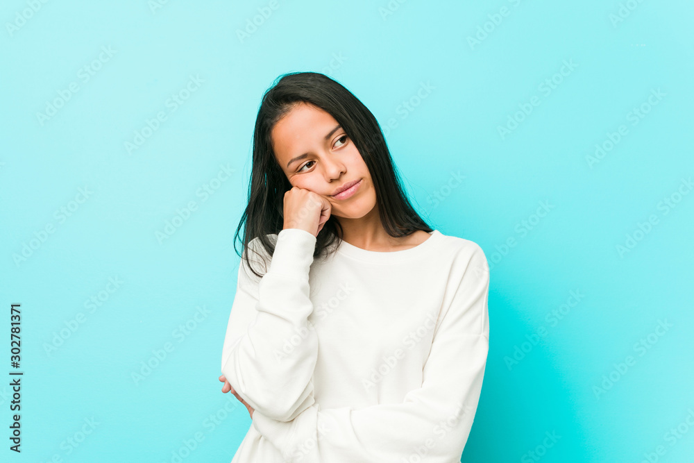 Young pretty hispanic woman who feels sad and pensive, looking at copy space. Young pretty hispanic woman who feels sad and pensive, looking at copy space.