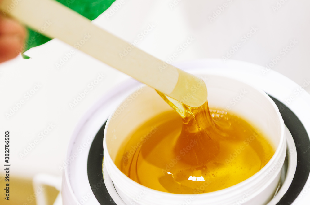 Hot wax in white bowl for hair removal Hot wax in white bowl for hair removal