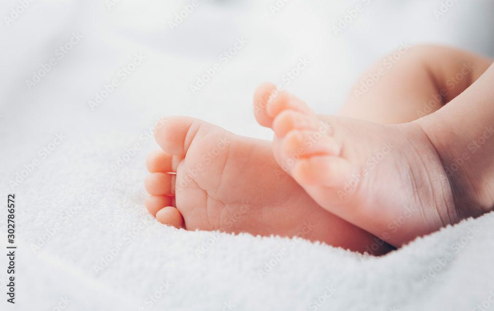 Newborn feet on soft white blanket Newborn feet on soft white blanket