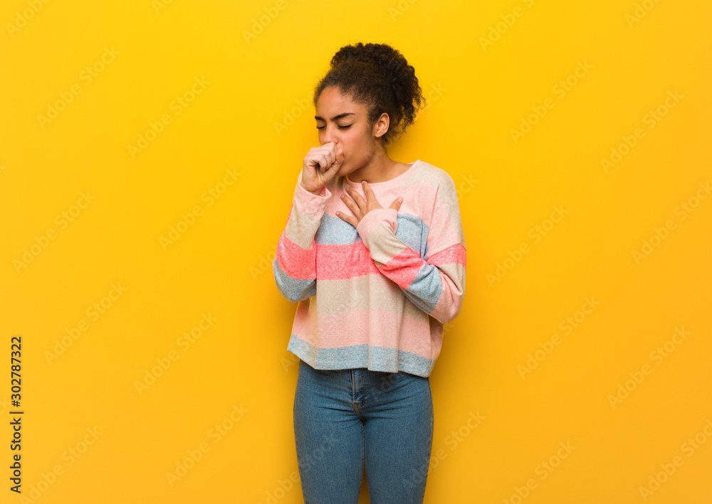 Young black african american girl with blue eyes coughing, sick due a virus or infection Young black african american girl with blue eyes coughing, sick due a virus or infection