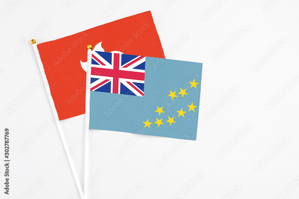 Tuvalu and Hong Kong stick flags on white background. High quality fabric, miniature national flag. Peaceful global concept.White floor for copy space. Tuvalu and Hong Kong stick flags on white background. High quality fabric, miniature national flag. Peaceful global concept.White floor for copy space.