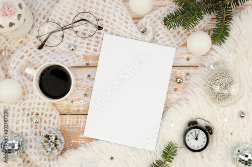 Magazine Cover mockup flat lay with Cup of black coffee, alarm clock, Christmas decoration and fir branches on a white rustic wooden background. Winter female magazine concept
