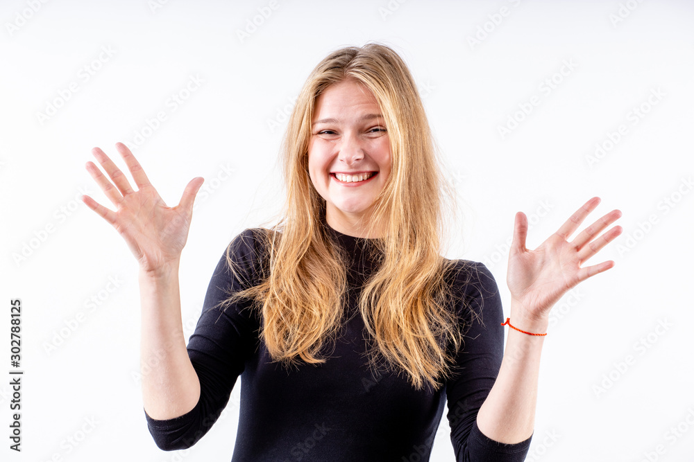 Fototapeta premium young beautiful blonde girl with a wide bright smile and outstretched arms on a white background