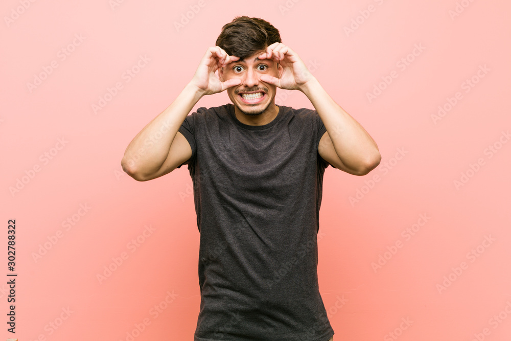 Young hispanic casual man keeping eyes opened to find a success opportunity. Young hispanic casual man keeping eyes opened to find a success opportunity.