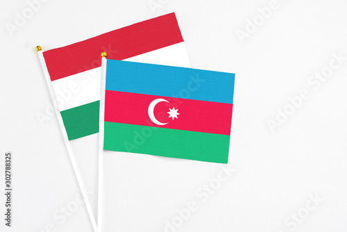 Free Download Azerbaijan and Hungary stick flags on white background. High quality fabric, miniature national flag. Peaceful global concept.White floor for copy space. - GFXLoad