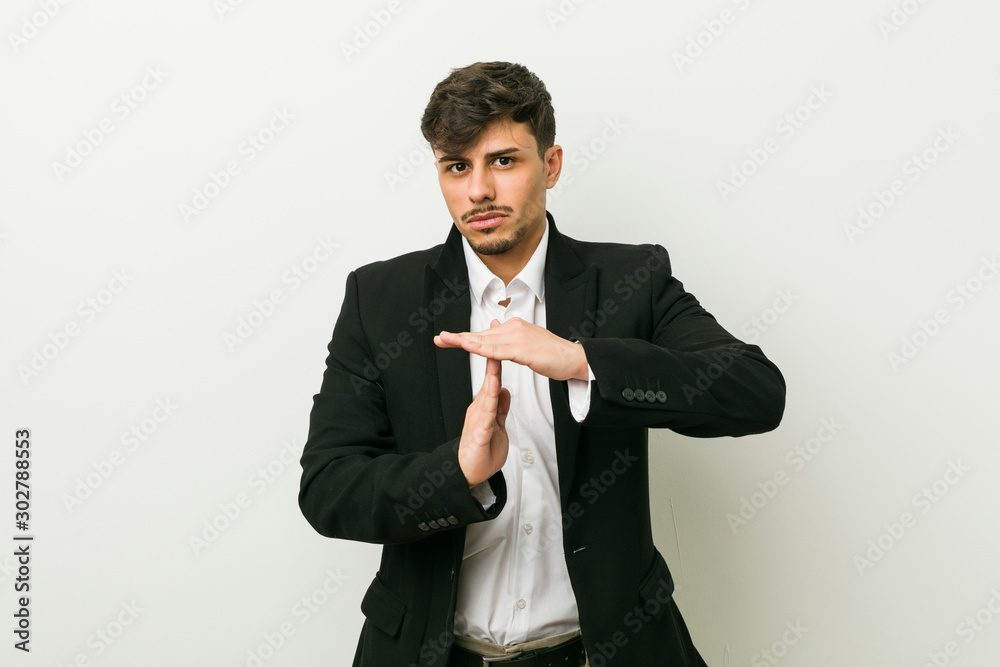 Young business hispanic man showing a timeout gesture. Young business hispanic man showing a timeout gesture.