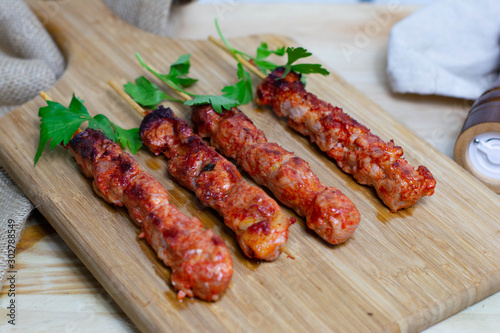 Pinchos morunos  or meat skewer. Typical Spanish cuisine dish made with pork or chicken carn marinated with garlic and paprika photo
