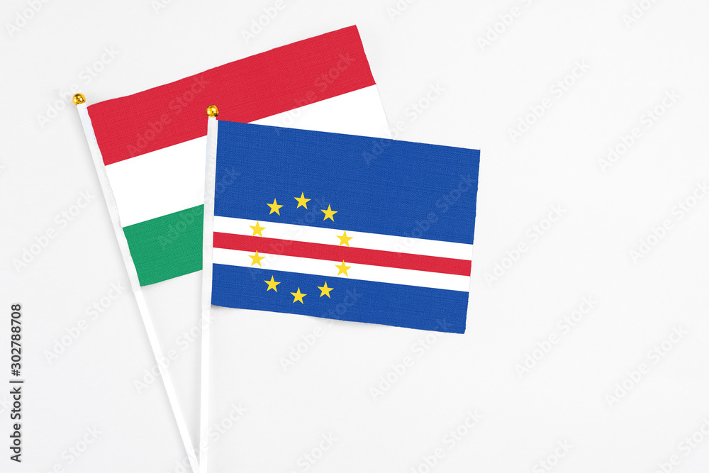 Cape Verde and Hungary stick flags on white background. High quality fabric, miniature national flag. Peaceful global concept.White floor for copy space.