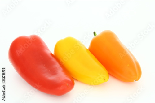 Fresh vegetables - colorful, sweet peppers on white background © Cezzar