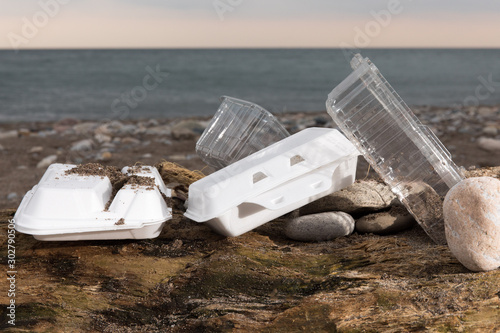 Tablou canvas plastic take out food foam clam shells polluting a sandy beach